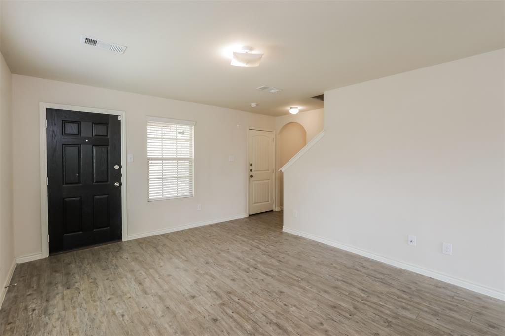 1605 Cardinal Drive Ennis, TX 75119 - Photo 5 of 16 wooden floor in an empty room with a window