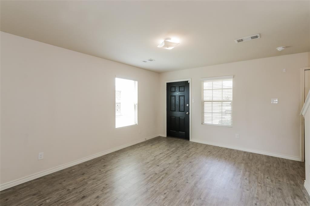 1605 Cardinal Drive Ennis, TX 75119 - Photo 6 of 16 a view of an empty room with a window and wooden floor