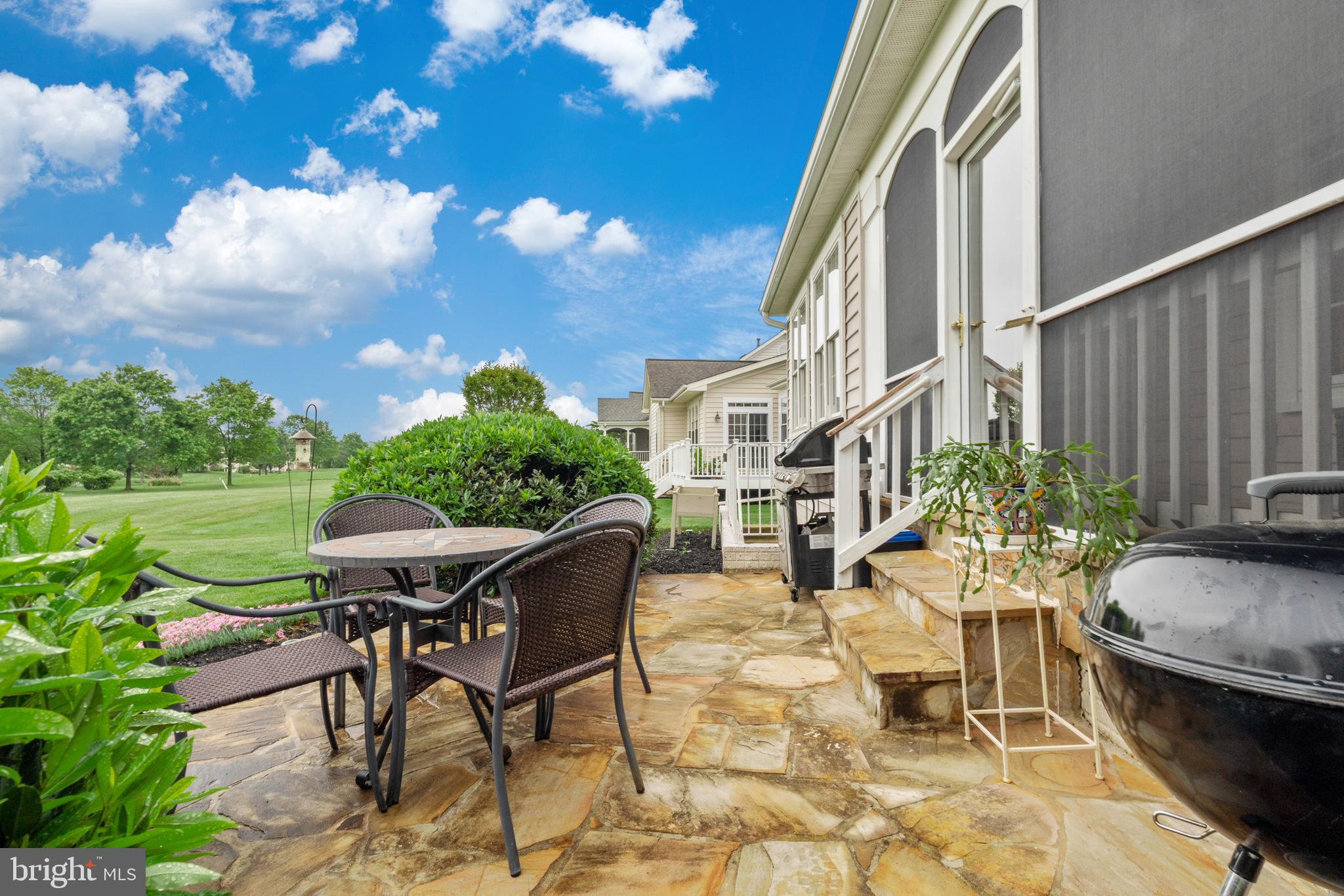 6051 Piney Grove Way Gainesville, VA 20155 - Photo 14 of 64 a view of a patio with table and chairs and potted plants