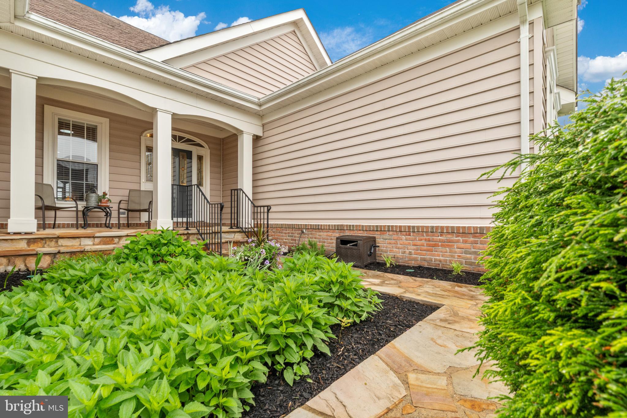 6051 Piney Grove Way Gainesville, VA 20155 - Photo 4 of 64 a front view of a house with garden