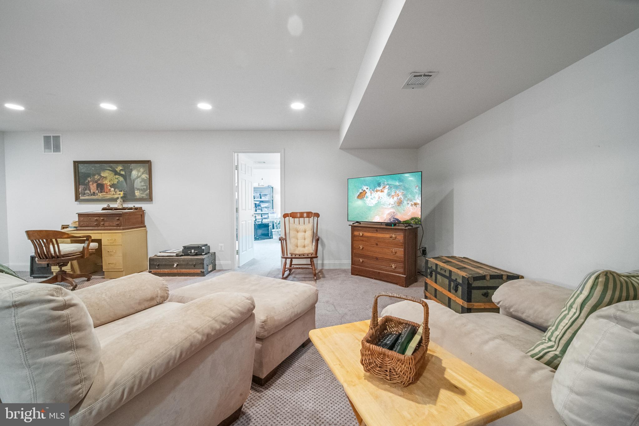 6051 Piney Grove Way Gainesville, VA 20155 - Photo 48 of 64 a living room with furniture and a flat screen tv