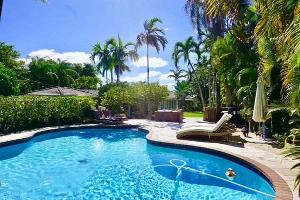 a view of swimming pool with outdoor seating and plants