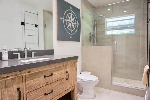 a bathroom with a toilet sink and shower