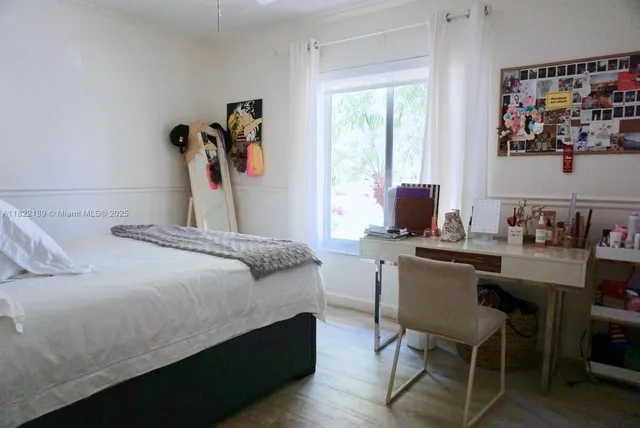 a bedroom with a bed and a desk