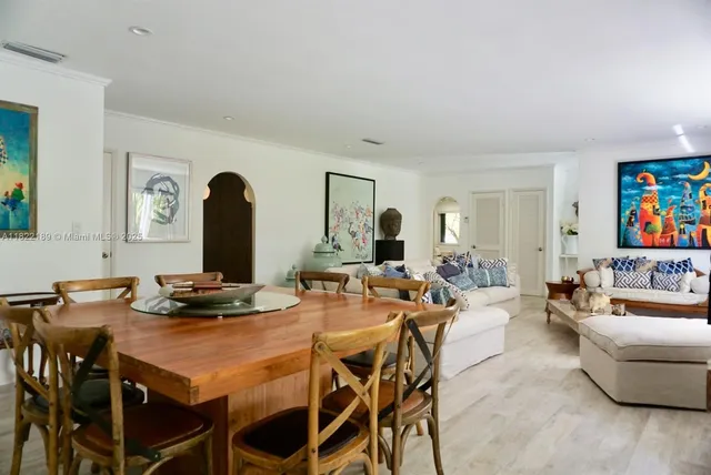 a dining room with furniture and wooden floor