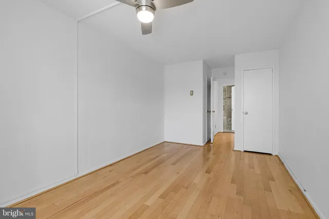 a view of empty room with wooden floor