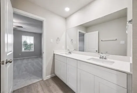 a bathroom with 2 sink and a mirror