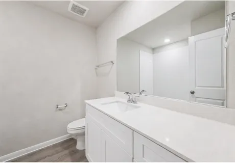 a bathroom with a sink a toilet and vanity