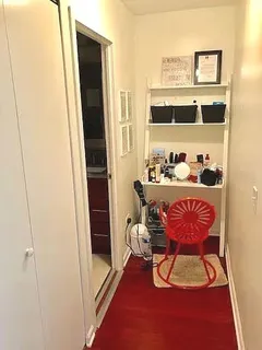 a view of a hallway with furniture and front door