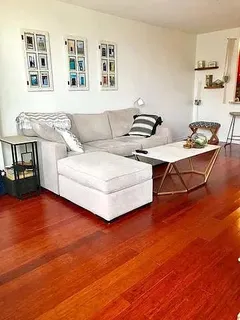 a living room with furniture and wooden floor