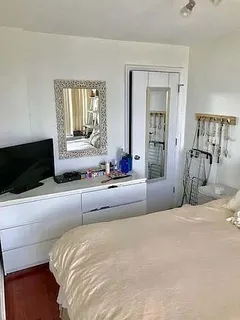 a bedroom with a bed and a television