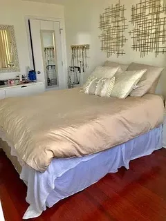 a bedroom with a bed and a mirror