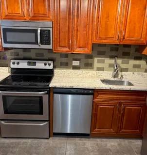 a kitchen with stainless steel appliances granite countertop a stove and a microwave
