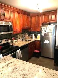 a kitchen with a stove a refrigerator and a sink