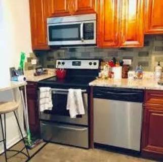 a kitchen with stainless steel appliances granite countertop a stove and a microwave