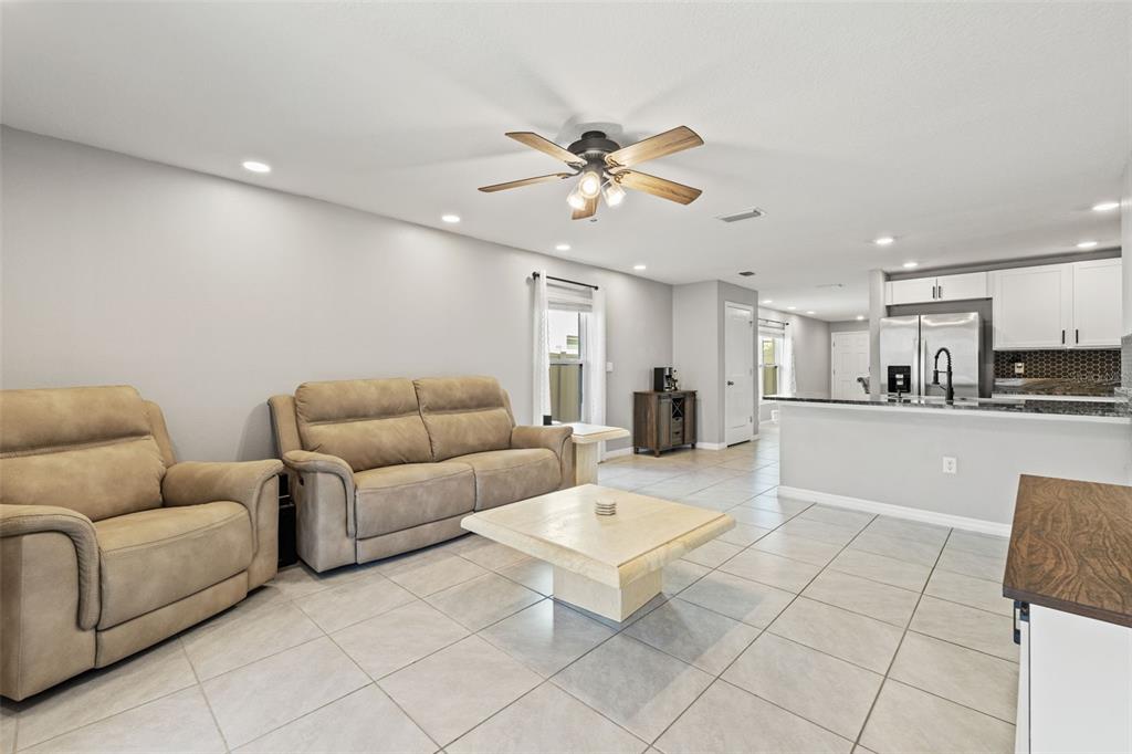 12115 Lily Magnolia Lane Riverview, FL 33569 - Photo 13 of 41 a living room with furniture and kitchen view