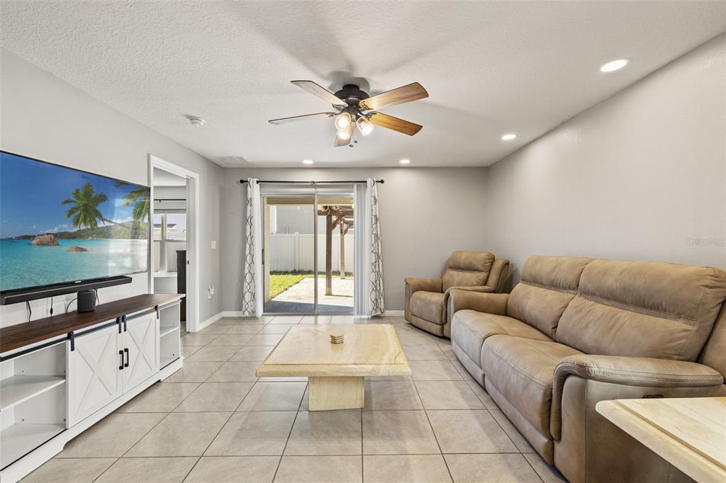 12115 Lily Magnolia Lane Riverview, FL 33569 - Photo 15 of 41 a living room with furniture and a flat screen tv