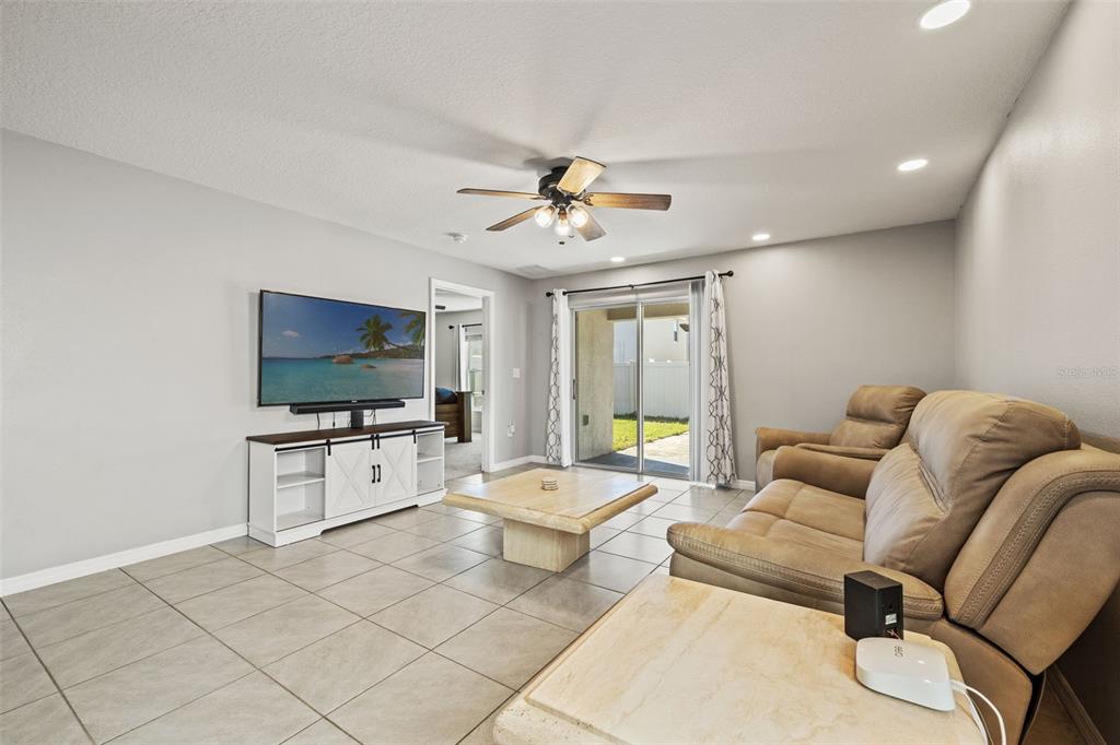 12115 Lily Magnolia Lane Riverview, FL 33569 - Photo 16 of 41 a living room with furniture and a flat screen tv