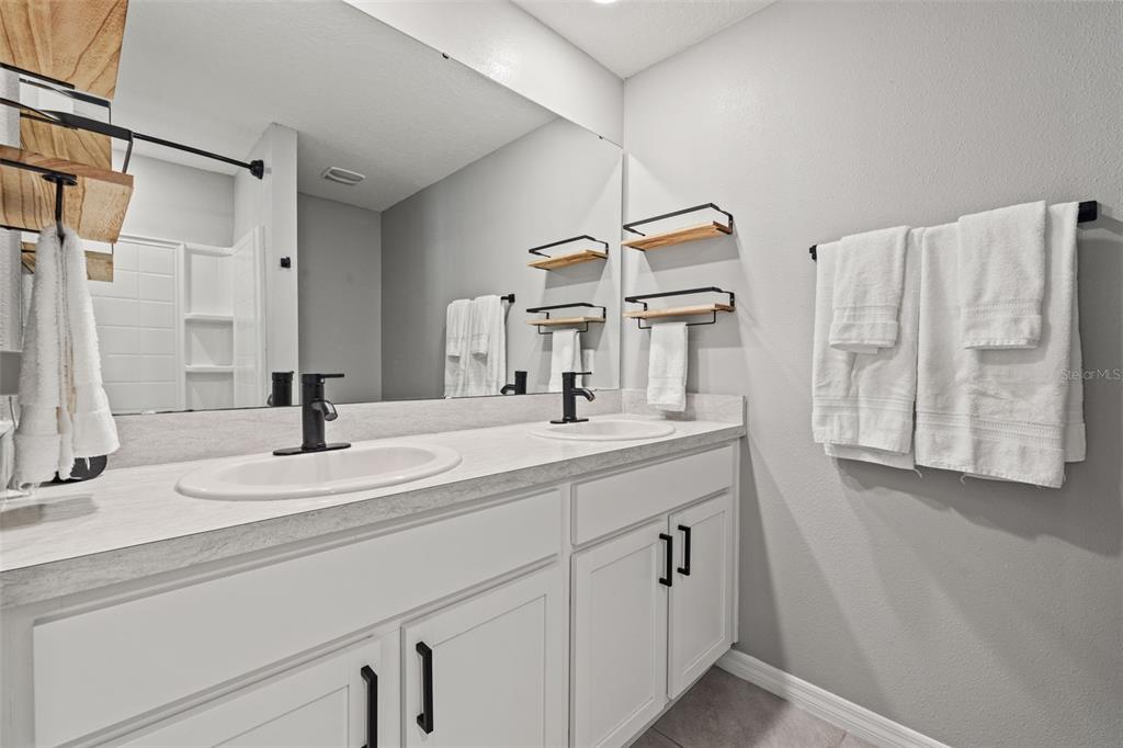 12115 Lily Magnolia Lane Riverview, FL 33569 - Photo 20 of 41 a bathroom with a double vanity sink and a mirror