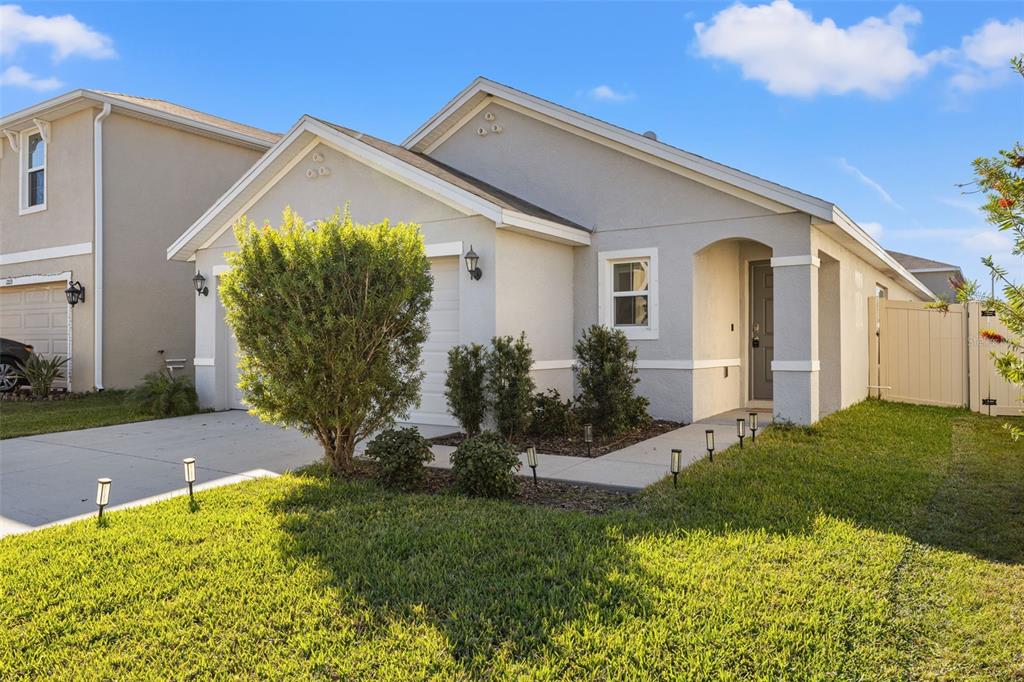 12115 Lily Magnolia Lane Riverview, FL 33569 - Photo 2 of 41 a front view of a house with garden