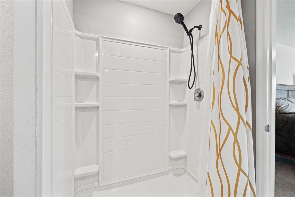 12115 Lily Magnolia Lane Riverview, FL 33569 - Photo 21 of 41 a bathroom with a shower