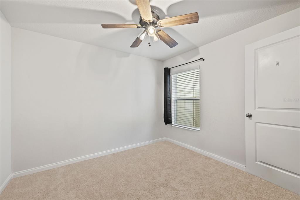12115 Lily Magnolia Lane Riverview, FL 33569 - Photo 25 of 41 an empty room with windows and fan