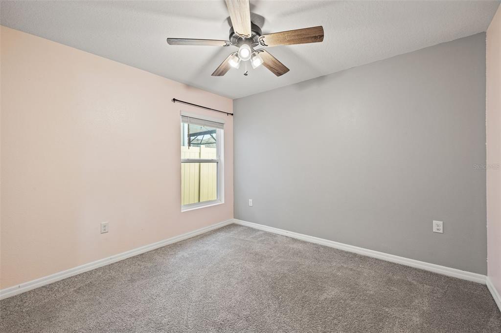 12115 Lily Magnolia Lane Riverview, FL 33569 - Photo 27 of 41 an empty room with windows and fan