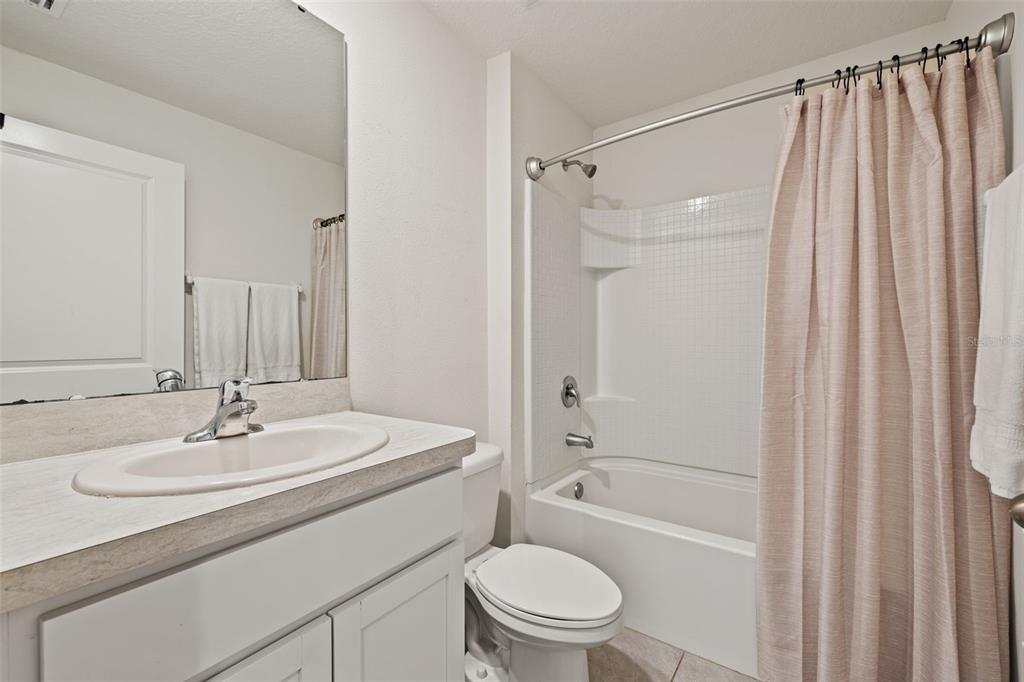 12115 Lily Magnolia Lane Riverview, FL 33569 - Photo 28 of 41 a bathroom with a sink toilet and shower