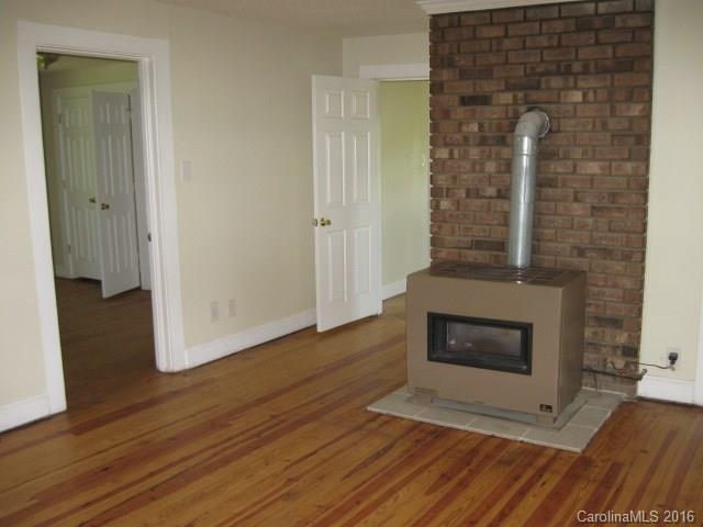 622 Gay Road Monroe, NC 28112 - Photo 14 of 24 a view of an empty room with wooden floor and a fireplace