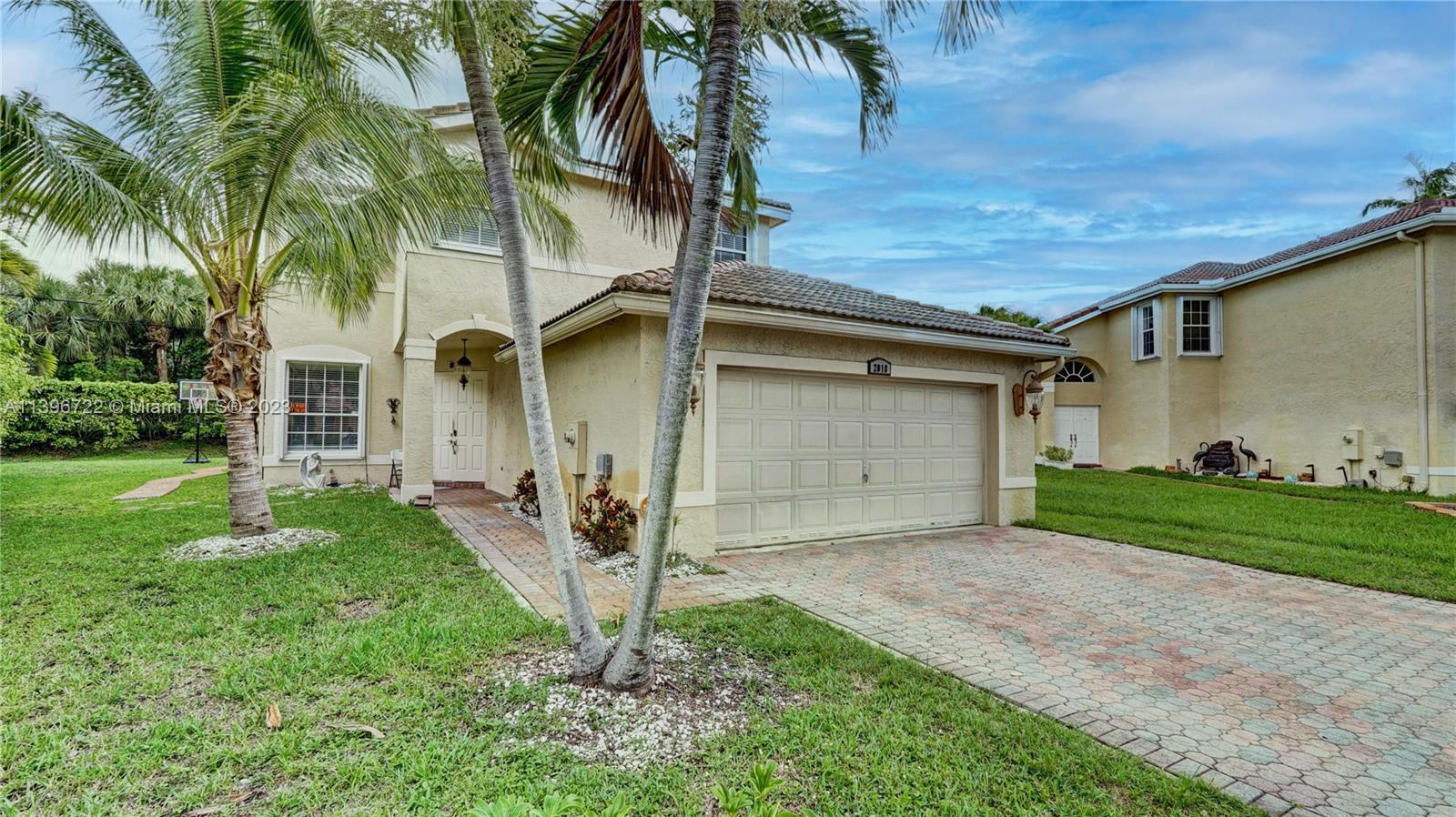 a front view of house with a garden