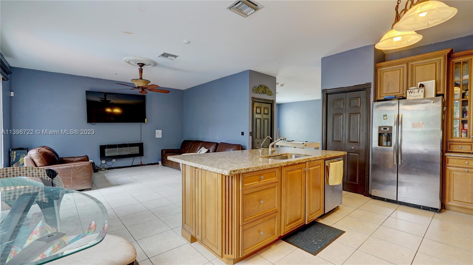 Silver Shores Miramar, FL 33027 - Photo 12 of 30 a kitchen with stainless steel appliances granite countertop a stove and a refrigerator