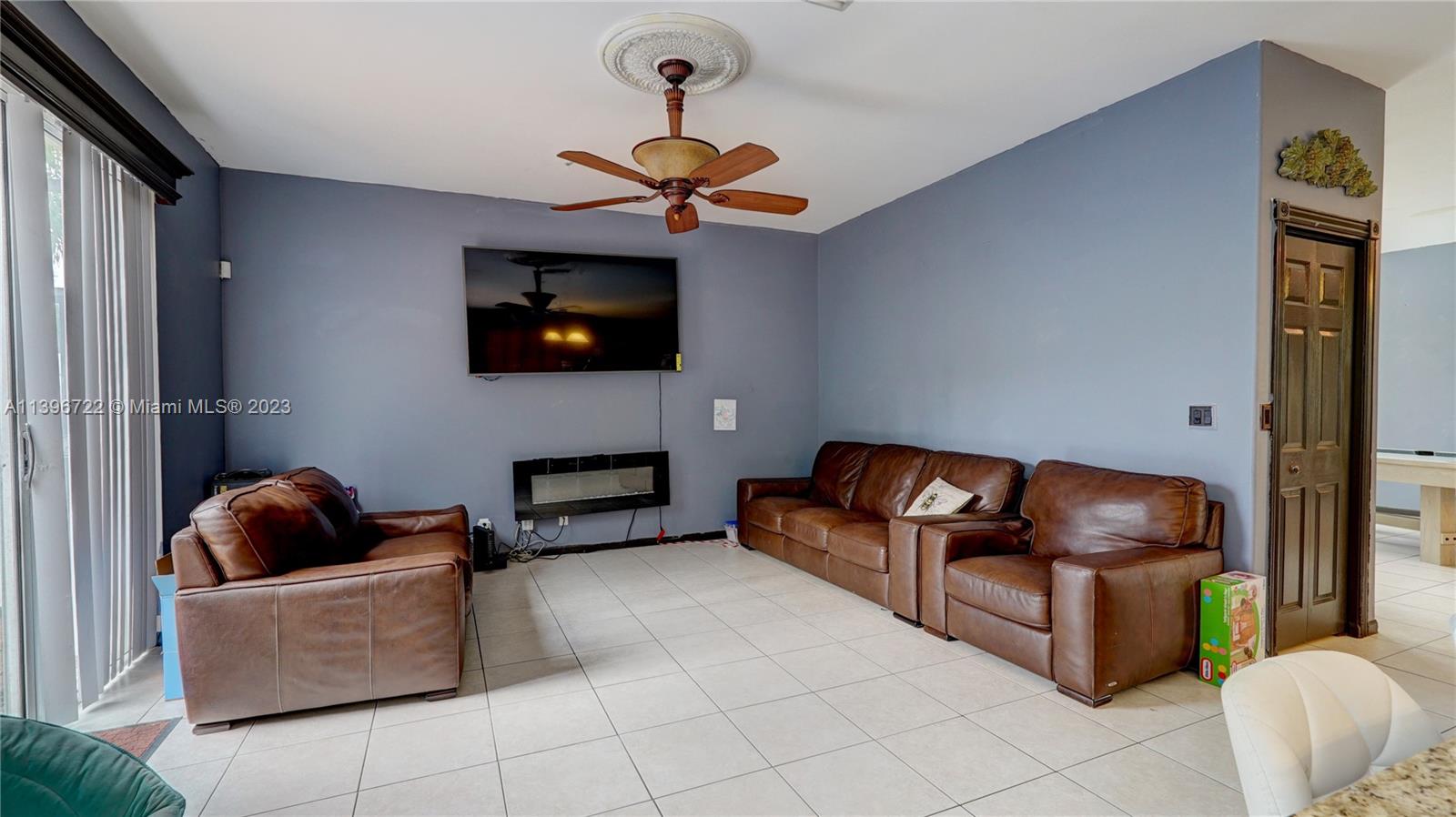 Silver Shores Miramar, FL 33027 - Photo 13 of 30 a living room with furniture and a flat screen tv