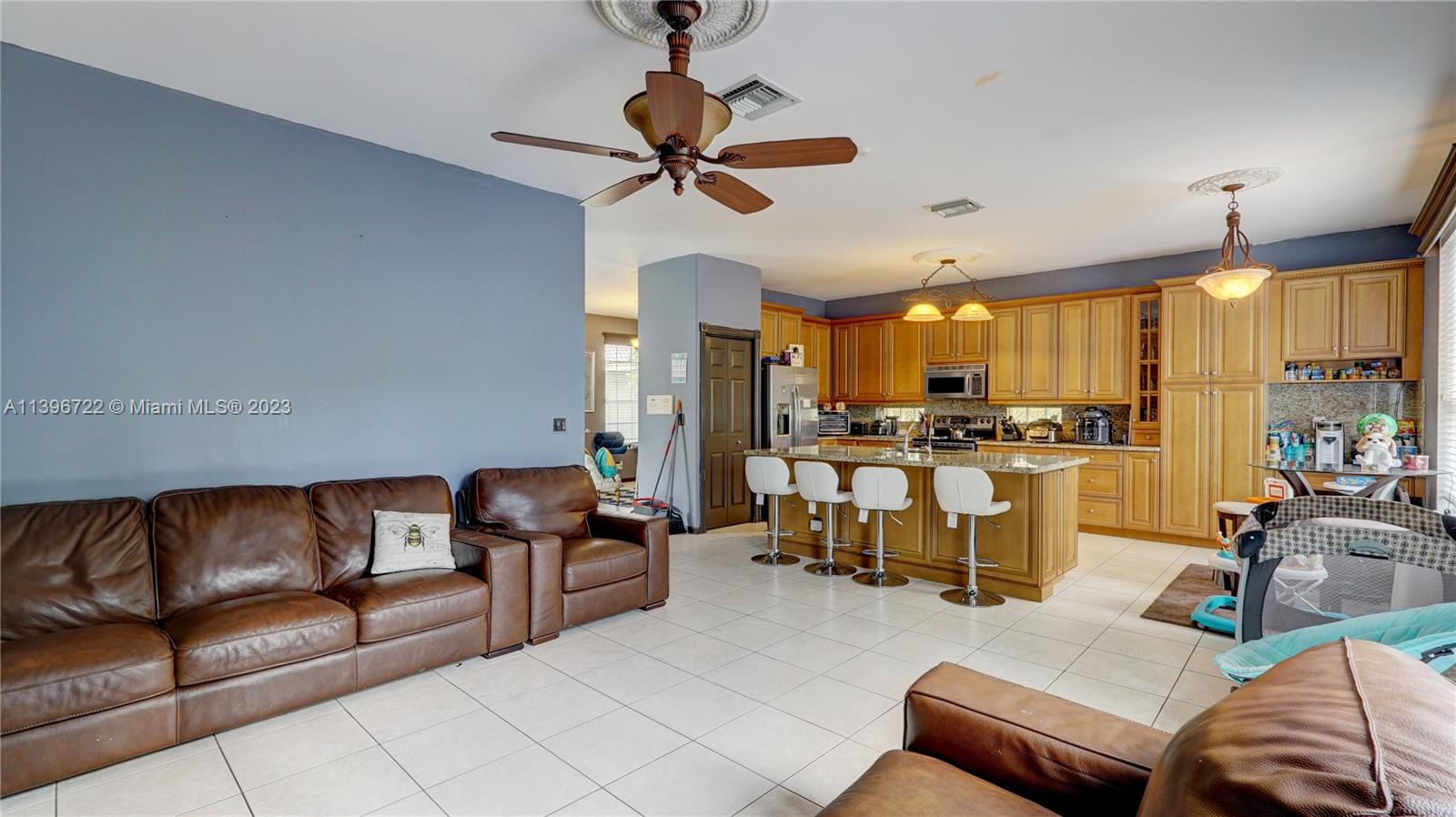 Silver Shores Miramar, FL 33027 - Photo 14 of 30 a living room with furniture kitchen view and a chandelier
