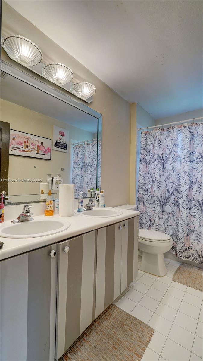 Silver Shores Miramar, FL 33027 - Photo 17 of 30 a bathroom with a sink a toilet and mirror