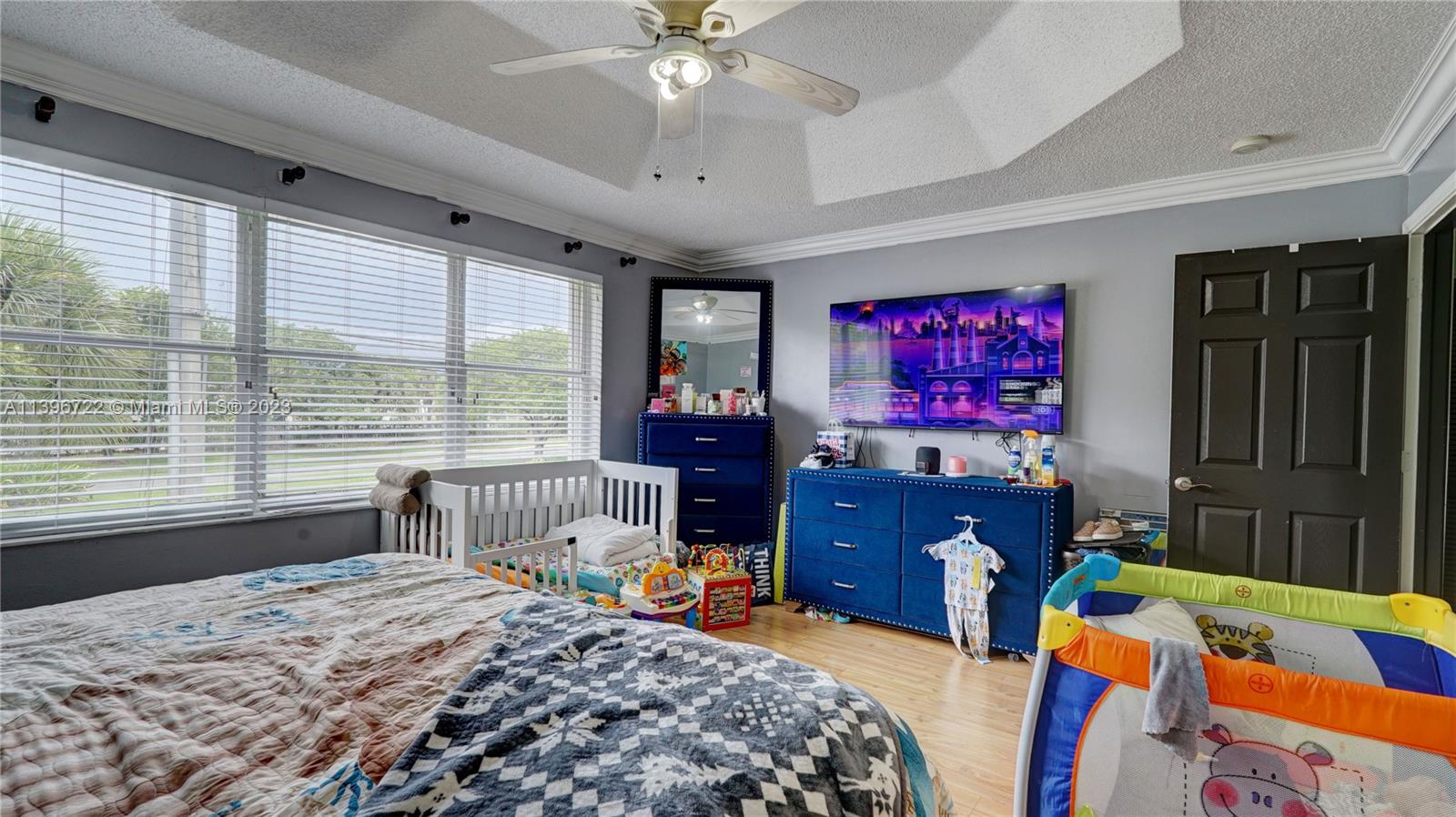 Silver Shores Miramar, FL 33027 - Photo 22 of 30 a bedroom with a bed and wooden floor