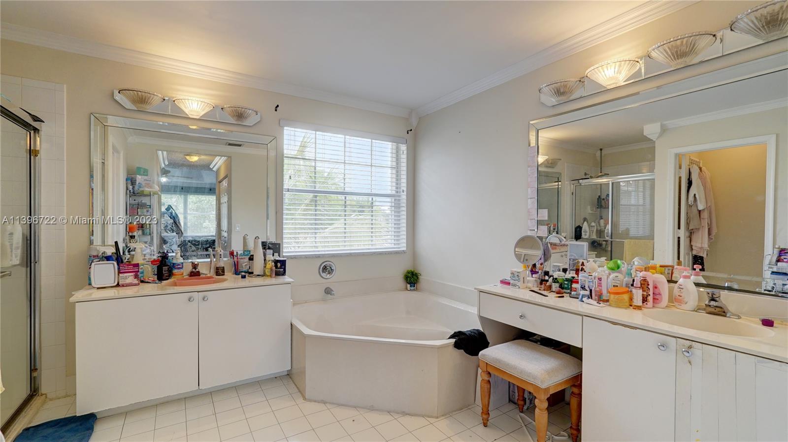 Silver Shores Miramar, FL 33027 - Photo 23 of 30 a bathroom with a tub sink double vanity and mirror