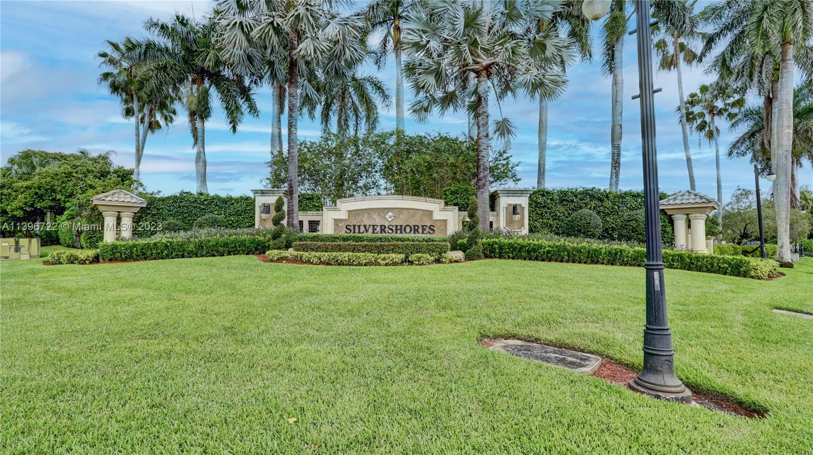 Silver Shores Miramar, FL 33027 - Photo 27 of 30 a front view of a house with a yard and palm trees