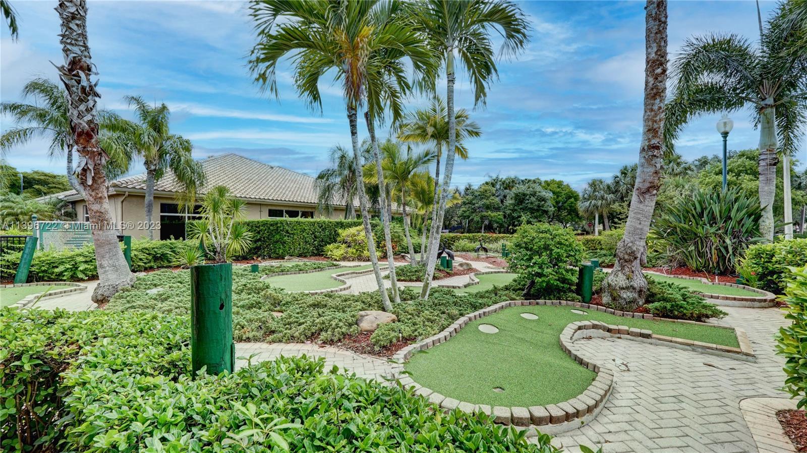 Silver Shores Miramar, FL 33027 - Photo 8 of 30 a view of a swimming pool with a garden