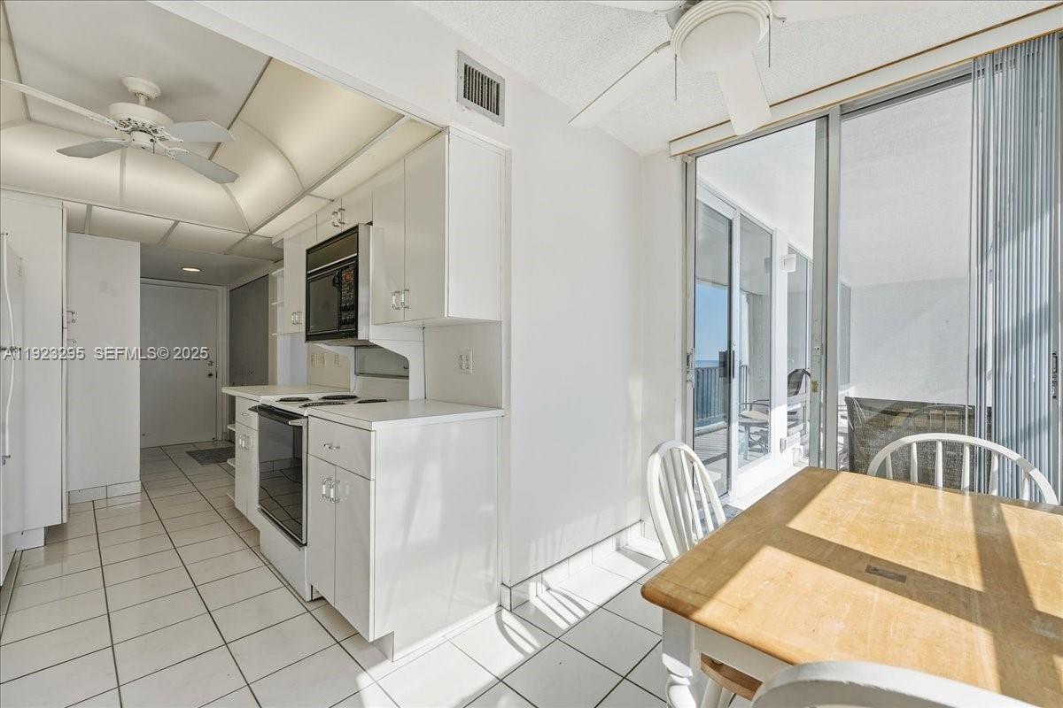 4280 Galt Ocean Drive, Unit 12H Fort Lauderdale, FL 33308 - Photo 11 of 31 a large kitchen with kitchen island a large counter space a sink stainless steel appliances and cabinets