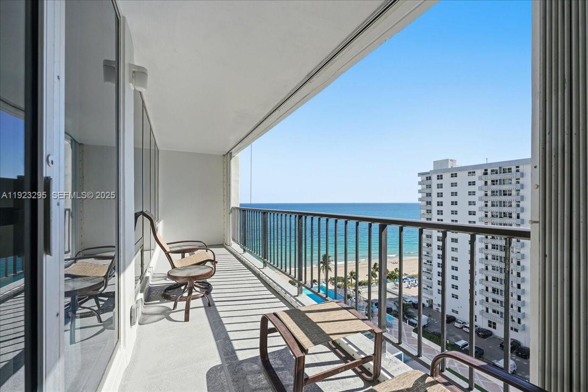 4280 Galt Ocean Drive, Unit 12H Fort Lauderdale, FL 33308 - Photo 14 of 31 a balcony with wooden floor table and chairs