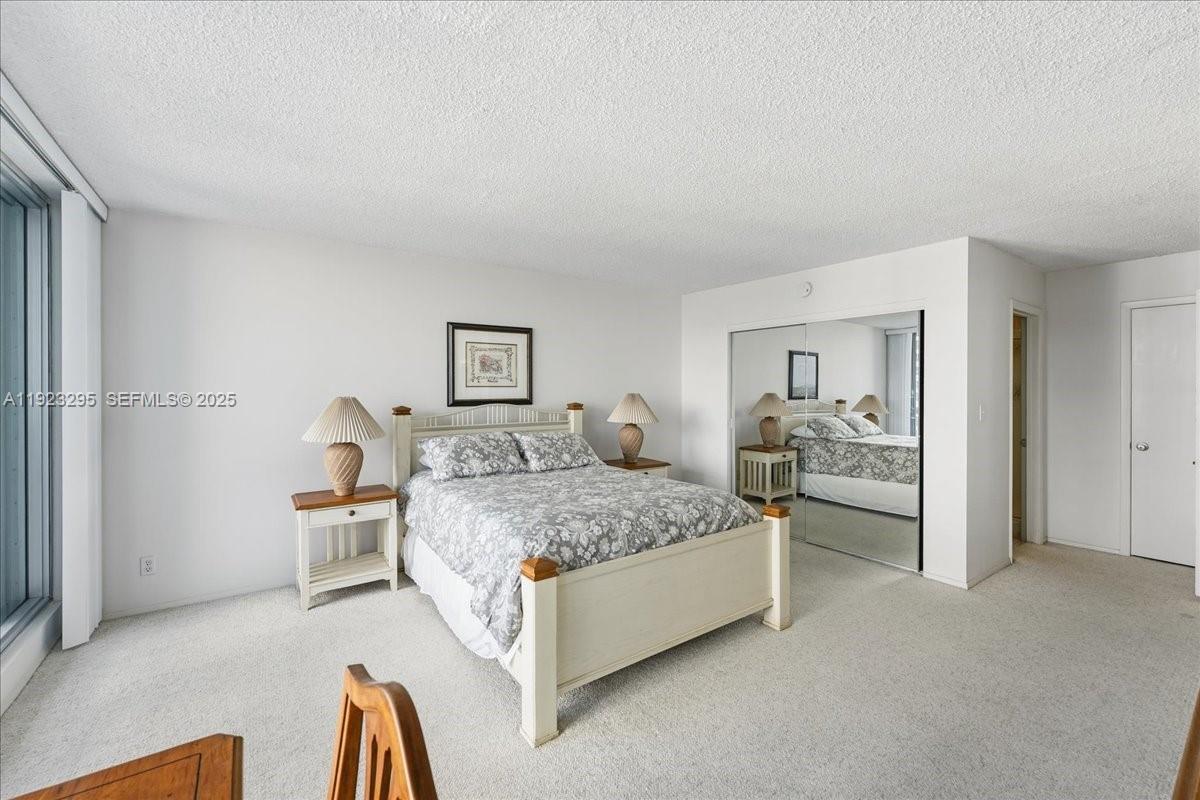 4280 Galt Ocean Drive, Unit 12H Fort Lauderdale, FL 33308 - Photo 15 of 31 a spacious bedroom with a bed and a couch