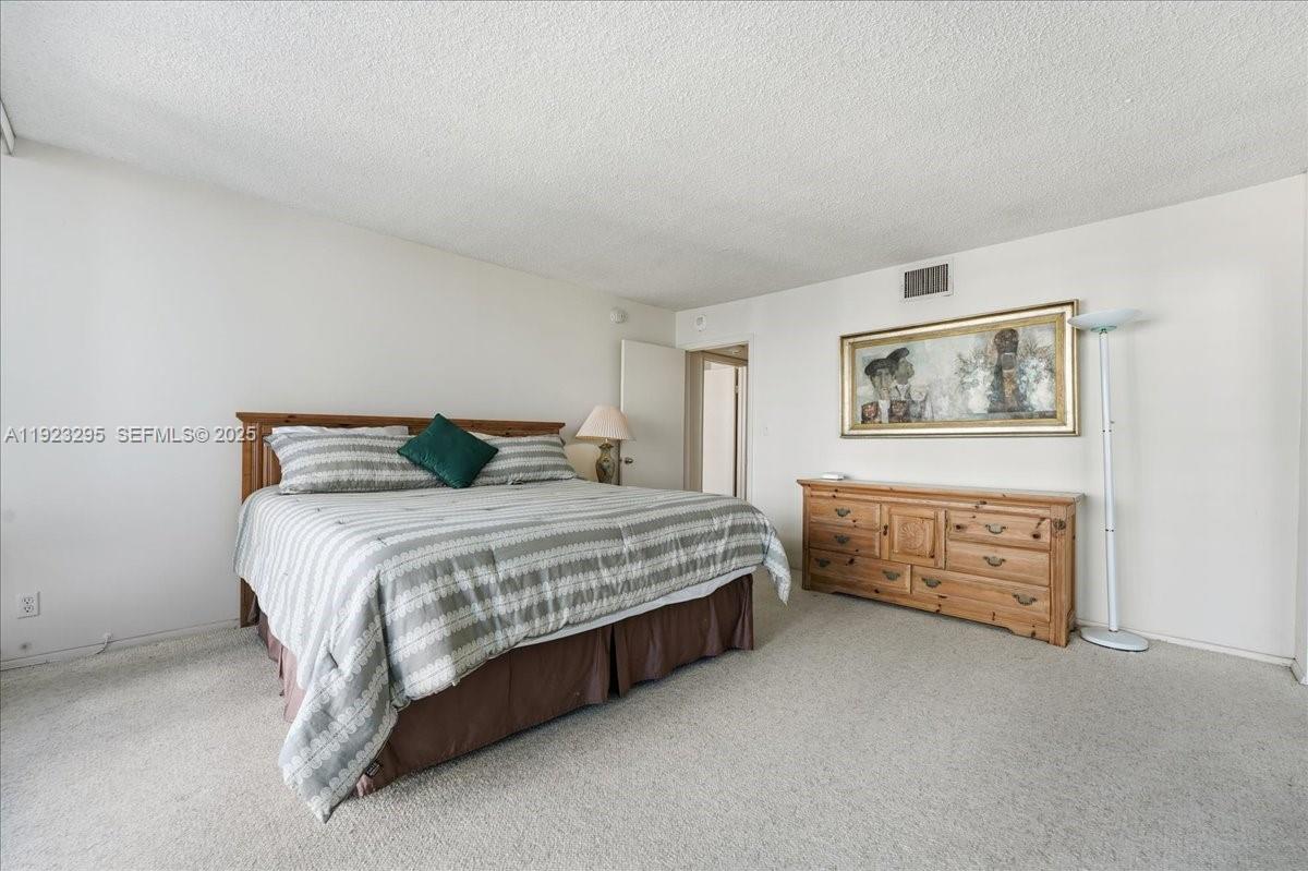 4280 Galt Ocean Drive, Unit 12H Fort Lauderdale, FL 33308 - Photo 20 of 31 a bedroom with a bed and a cabinets