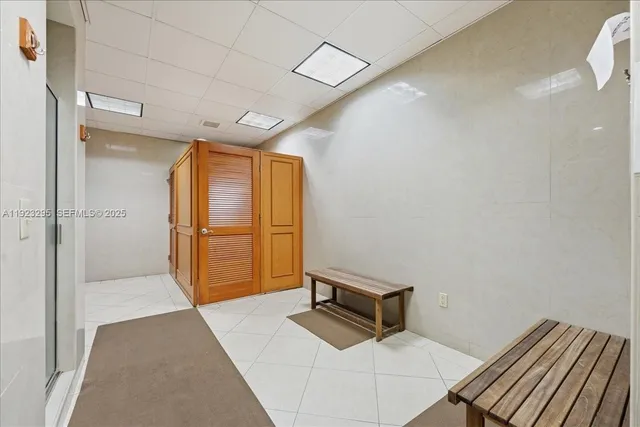 a hallway with sliding door and wooden floor