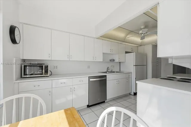 a kitchen with a sink cabinets and appliances
