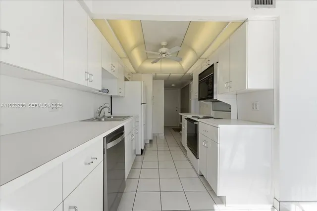 a kitchen with stainless steel appliances granite countertop a sink and cabinets
