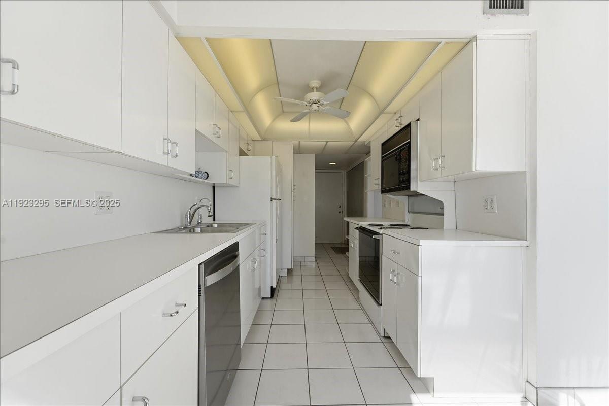 4280 Galt Ocean Drive, Unit 12H Fort Lauderdale, FL 33308 - Photo 10 of 31 a kitchen with stainless steel appliances granite countertop a sink and cabinets