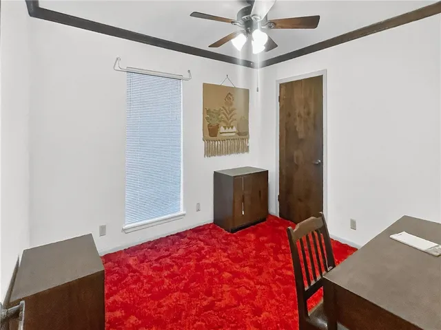 a bedroom with a bed and a desk