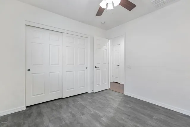 an empty room with a empty space and a ceiling fan