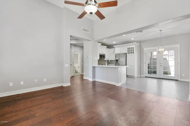 a view of a kitchen with a sink dishwasher a refrigerator and wooden floor