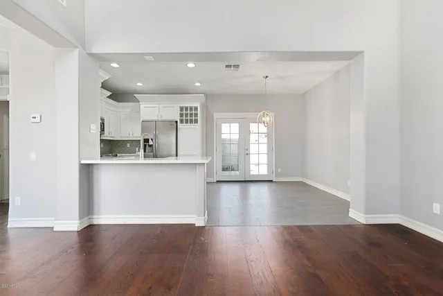 a view of kitchen with refrigerator and window